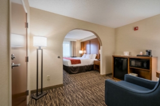 Photo shows accessible room with wide doorway and room around bed for wheelchair.