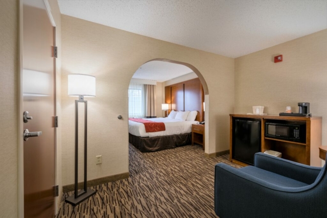 Photo shows accessible room with wide doorway and room around bed for wheelchair.